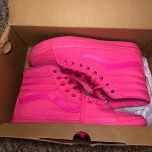 Neon pink high top vans.